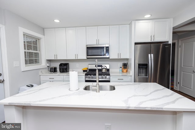 916 Phillip Powers Dr, Laurel, MD 20707 - kitchen with light stone counters, a center island with sink, recessed lighting, appliances with stainless steel finishes, and white cabinetry