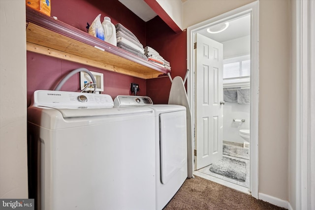 laundry room featuring laundry area, washing machine and dryer, and carpet