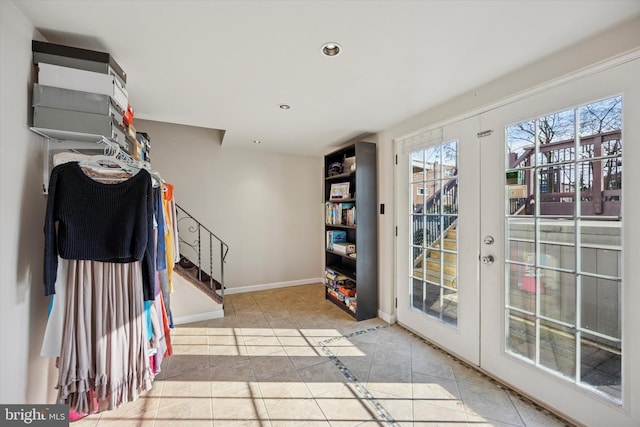 doorway featuring french doors, stairway, baseboards, and tile patterned floors