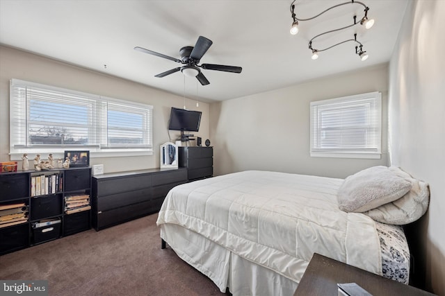 bedroom featuring rail lighting, carpet flooring, and ceiling fan