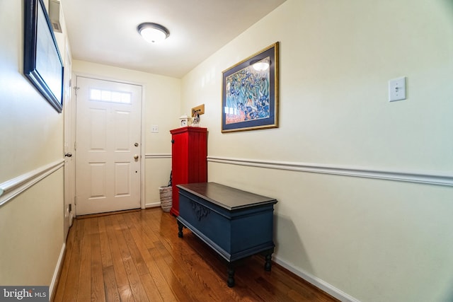 doorway to outside featuring hardwood / wood-style flooring and baseboards