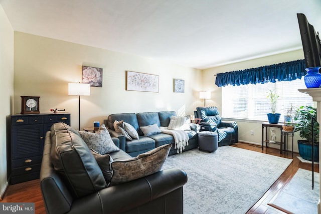 living area featuring wood finished floors and baseboards