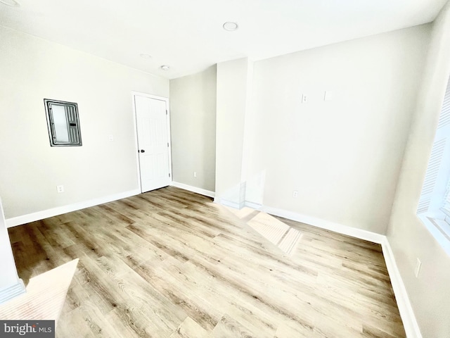 empty room with baseboards and wood finished floors