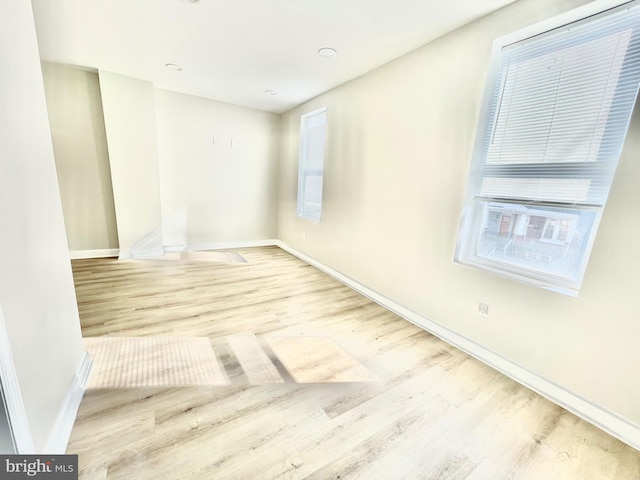 unfurnished room with baseboards and wood finished floors