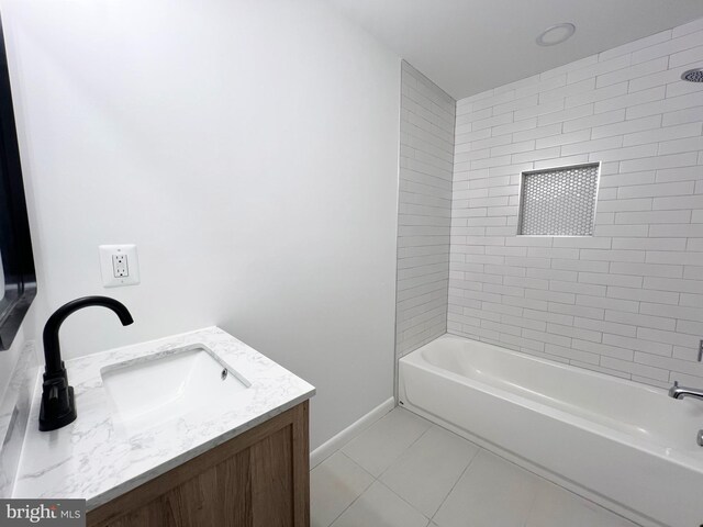 bathroom featuring tile patterned flooring, baseboards, shower / bathing tub combination, and vanity