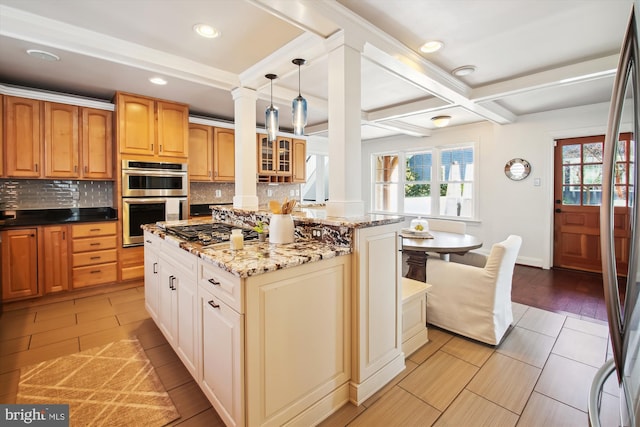 kitchen featuring dark stone counters, stainless steel appliances, tasteful backsplash, and glass insert cabinets