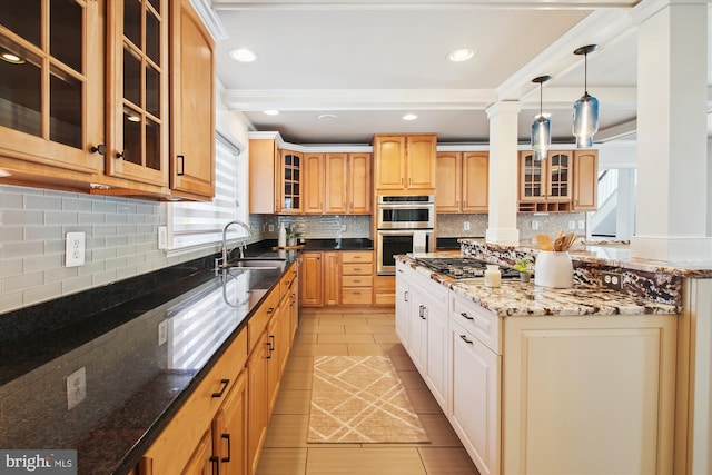 kitchen featuring stainless steel appliances, dark stone counters, glass insert cabinets, and a sink