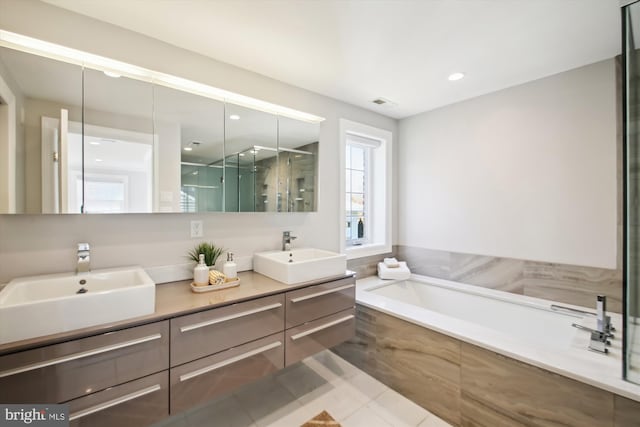 full bath featuring double vanity, a sink, a bath, and a shower stall