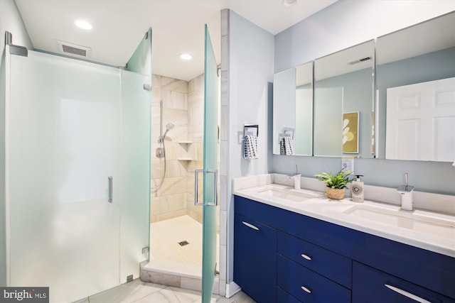 full bath with double vanity, a stall shower, visible vents, and a sink