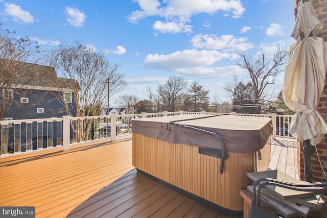 wooden deck with a hot tub