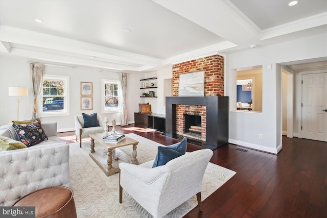 living area featuring a raised ceiling, baseboards, a fireplace, and hardwood / wood-style floors