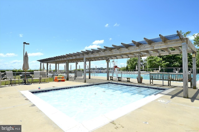 pool featuring a patio area and a pergola