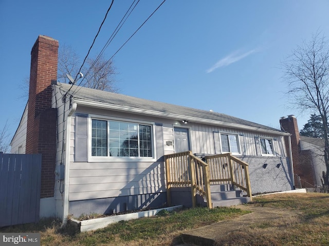 view of front of house featuring a chimney