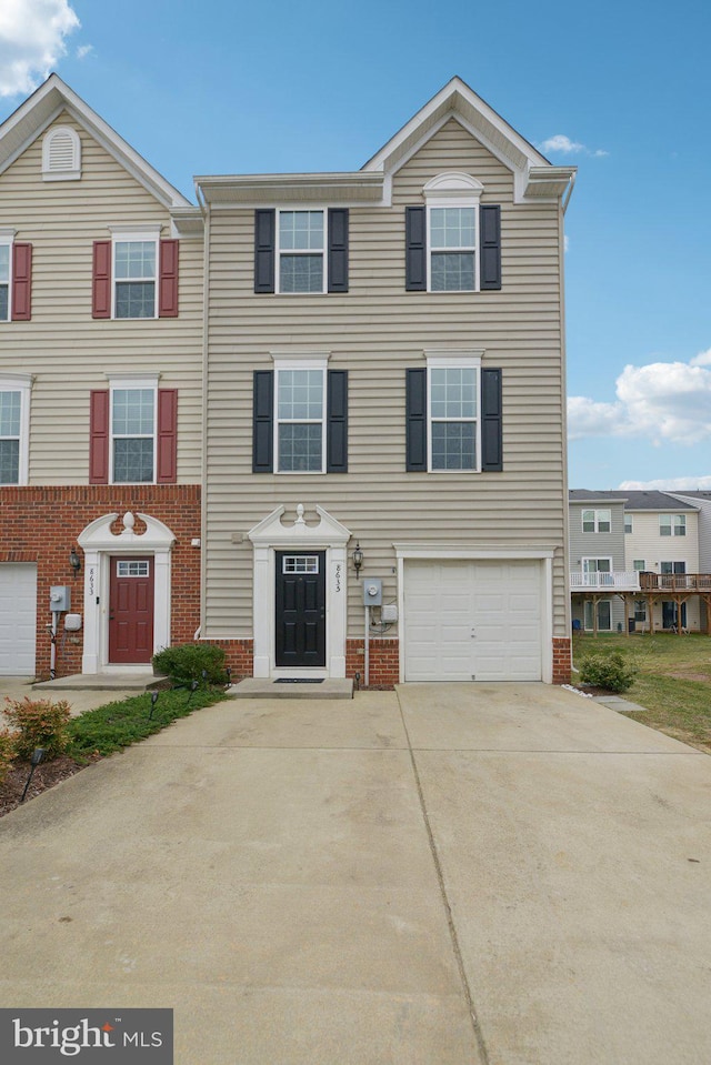 view of property featuring concrete driveway, brick siding, and an attached garage