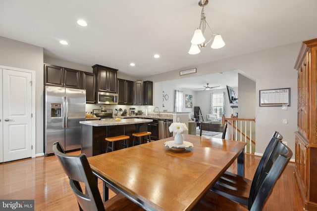 dining space with light wood-type flooring, ceiling fan, baseboards, and recessed lighting