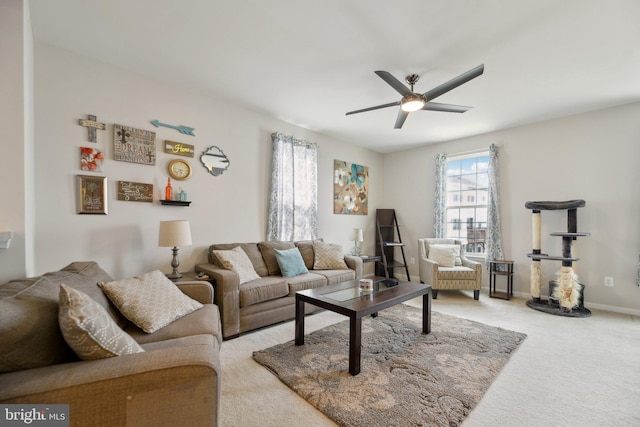 living room featuring carpet floors, baseboards, and a ceiling fan