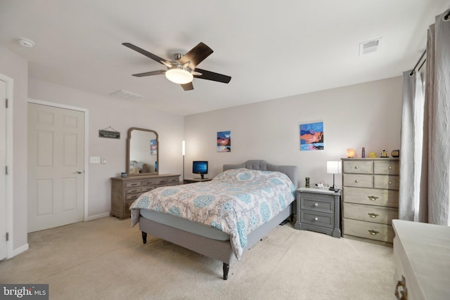 bedroom featuring ceiling fan, baseboards, visible vents, and light colored carpet