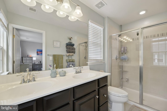 full bathroom featuring a shower stall, visible vents, and a sink