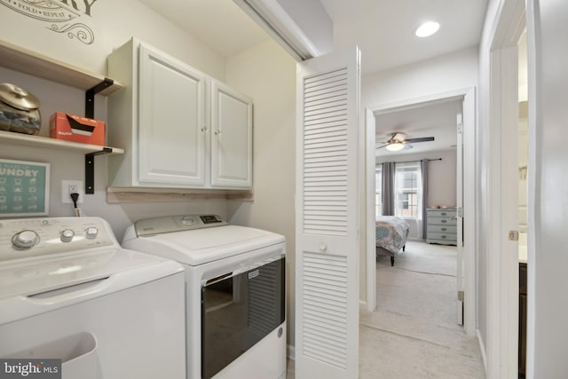 laundry room with ceiling fan, separate washer and dryer, cabinet space, and light colored carpet