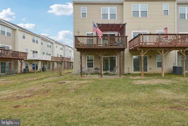 back of house with central AC and a yard