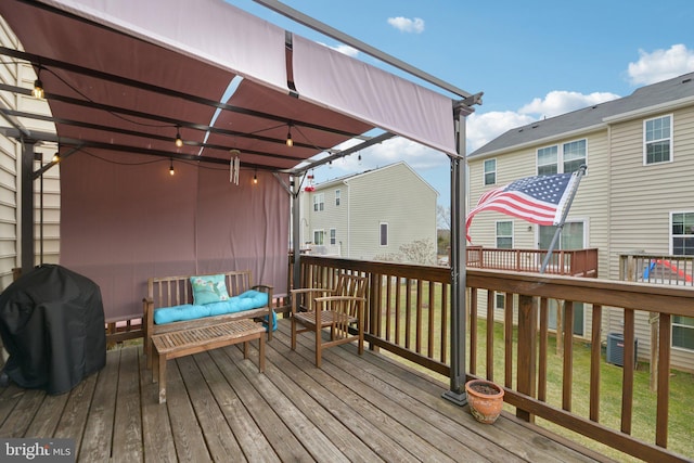 deck with grilling area and a pergola