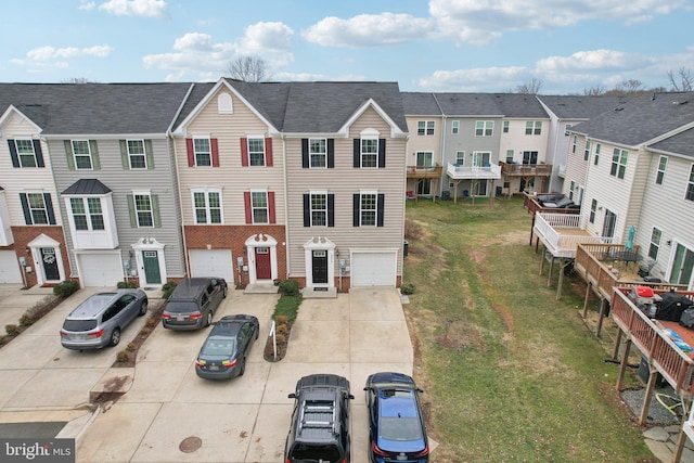 view of front of house featuring driveway, an attached garage, and a residential view