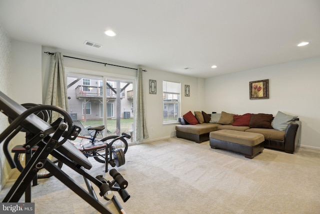 workout area featuring baseboards, recessed lighting, visible vents, and light colored carpet