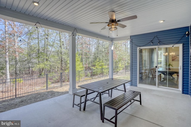 view of patio with fence and a ceiling fan