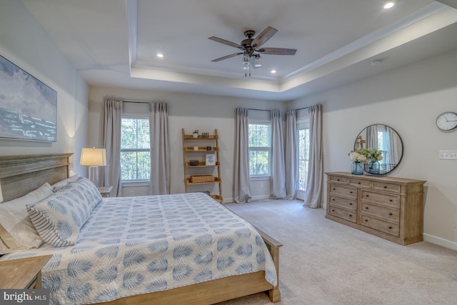 bedroom with baseboards, a tray ceiling, recessed lighting, and light colored carpet