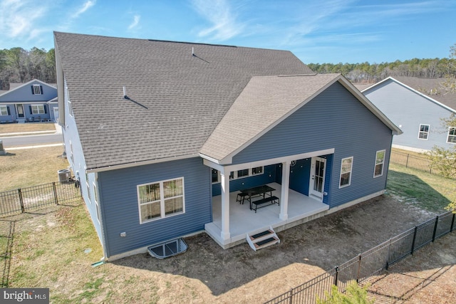 back of property featuring cooling unit, a fenced backyard, a patio, and roof with shingles