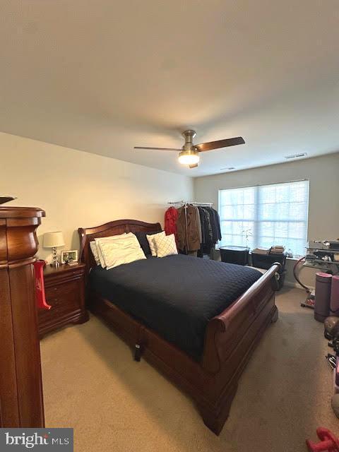 bedroom featuring carpet, visible vents, and a ceiling fan