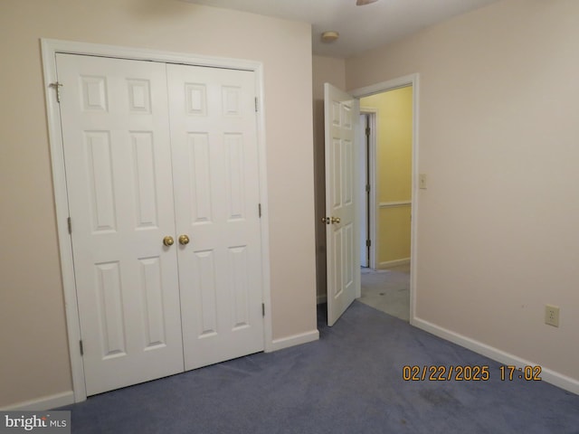 unfurnished bedroom featuring carpet, a closet, and baseboards