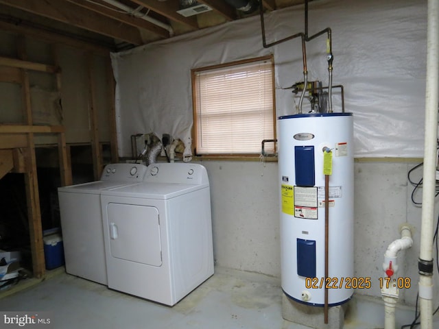 clothes washing area featuring laundry area, water heater, and separate washer and dryer