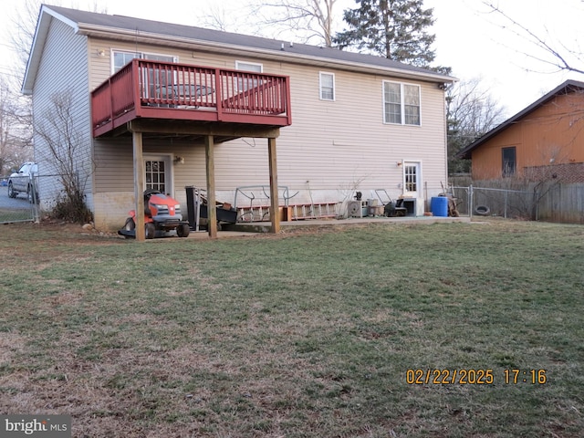 rear view of house with a deck, a yard, fence, and central air condition unit