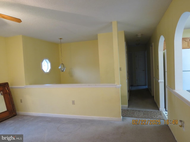 interior space with ceiling fan and baseboards