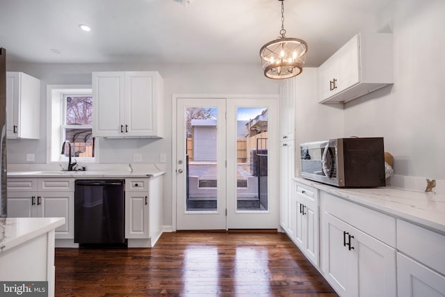 kitchen featuring dark wood-style flooring, stainless steel microwave, dishwasher, and white cabinetry