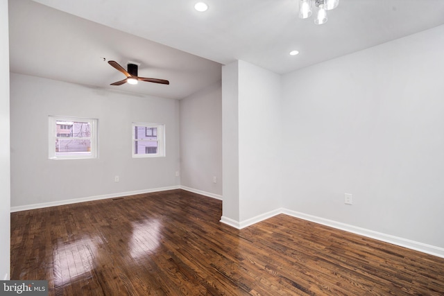 spare room with ceiling fan, dark wood-type flooring, recessed lighting, and baseboards