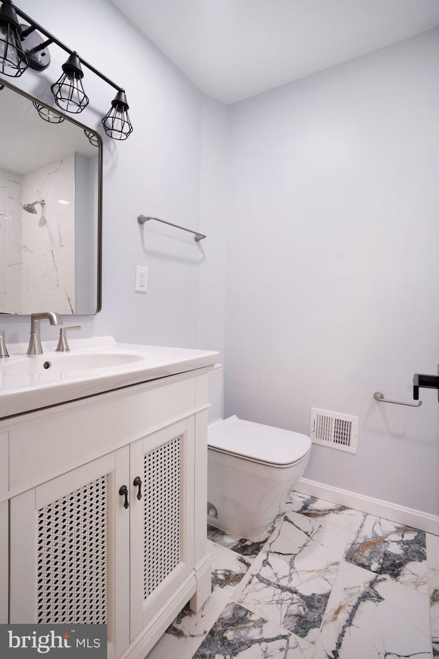 bathroom featuring toilet, marble finish floor, visible vents, and vanity