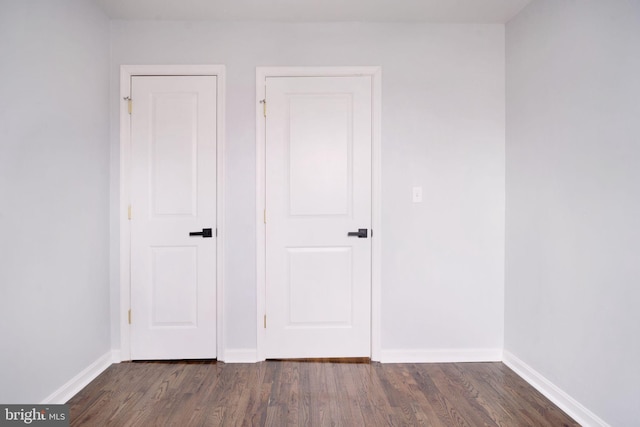 interior space featuring dark wood finished floors and baseboards