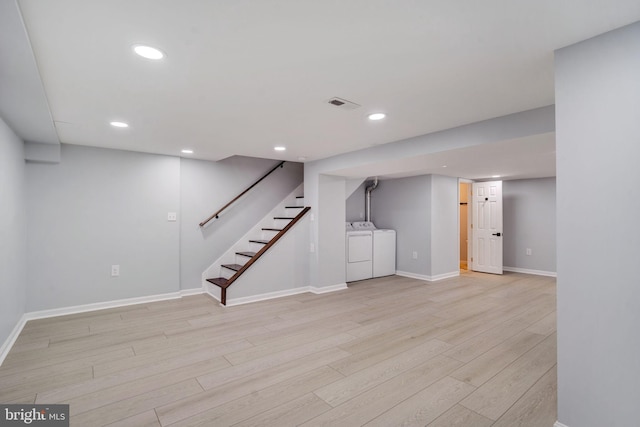 finished below grade area with recessed lighting, visible vents, baseboards, stairs, and light wood-style floors