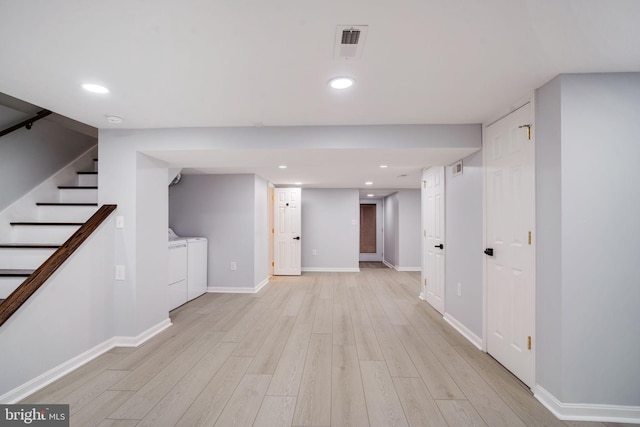 finished basement featuring recessed lighting, visible vents, separate washer and dryer, light wood-type flooring, and stairs