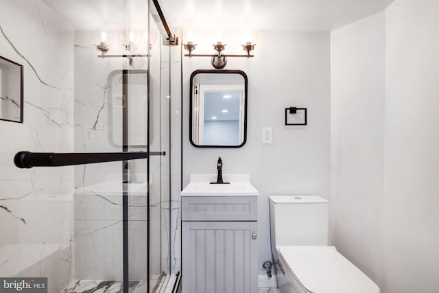 bathroom featuring toilet, a marble finish shower, and vanity