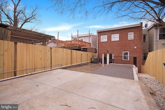 exterior space featuring cooling unit and fence