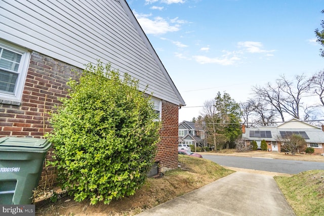 view of side of property featuring brick siding