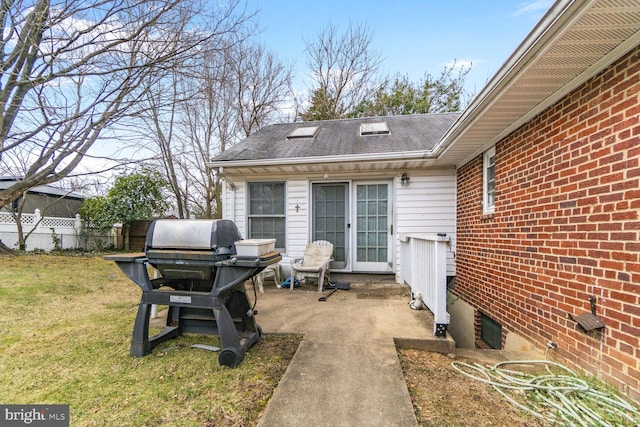 view of patio featuring area for grilling and fence