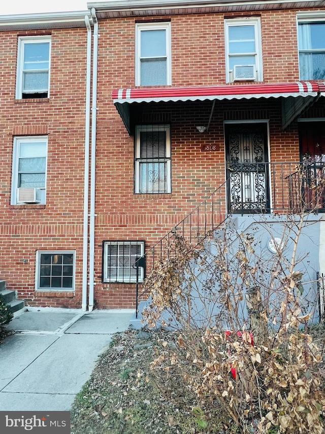 view of front of home with brick siding and cooling unit