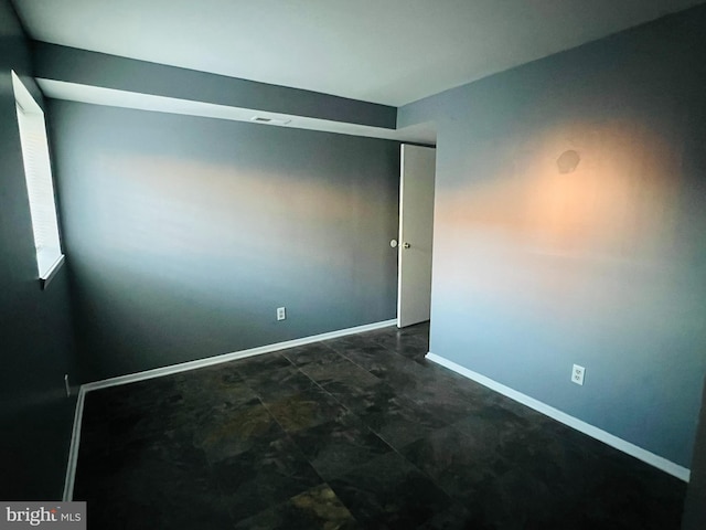 empty room with visible vents and baseboards