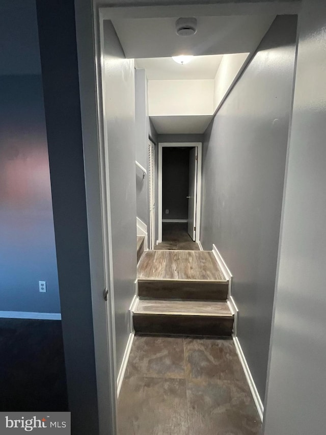 staircase featuring baseboards