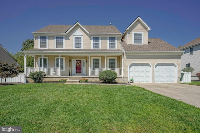 colonial home featuring covered porch, fence, a garage, driveway, and a front lawn