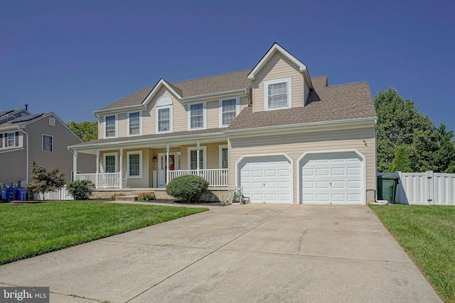 view of front of home featuring covered porch, a garage, fence, concrete driveway, and a front yard